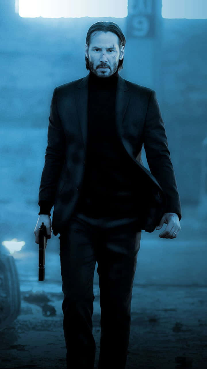 Keanu Reeves striking an intense pose in a black three-piece suit