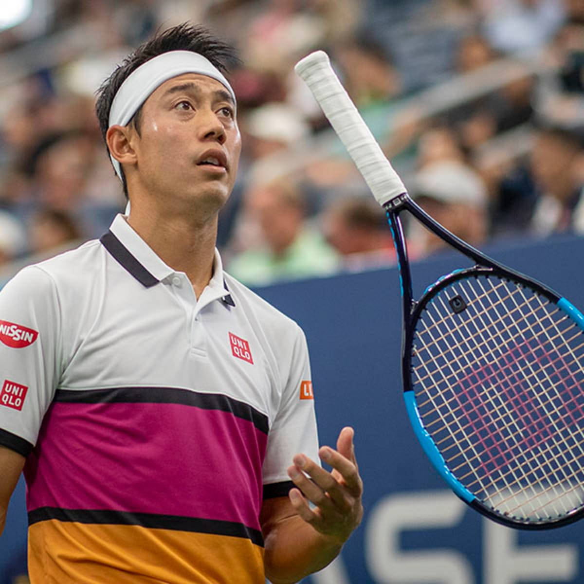Kei Nishikori Expertly Performs a Racket Flip During a Match Wallpaper