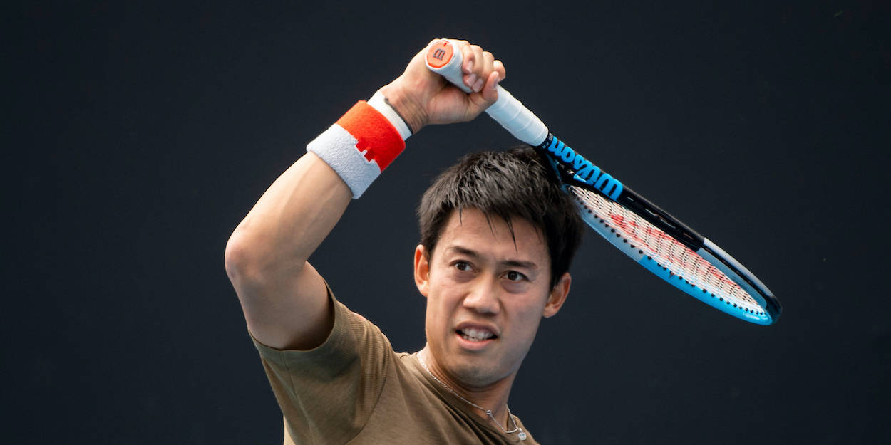 a man holding a tennis racket Wallpaper