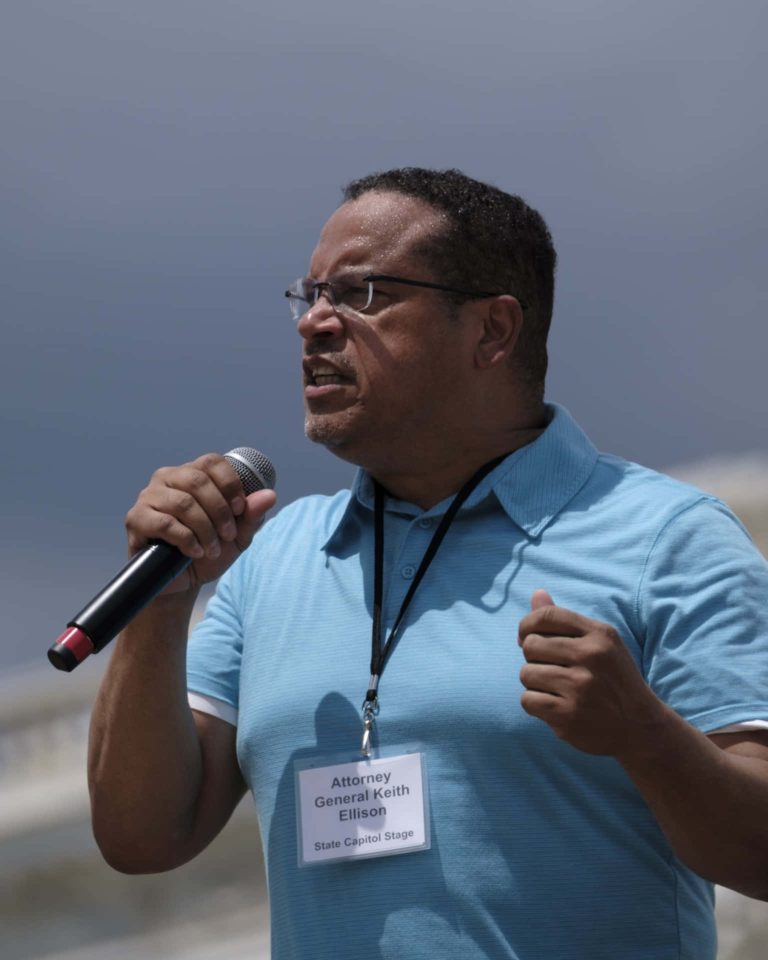 Keith Ellison Holding Microphone Wallpaper