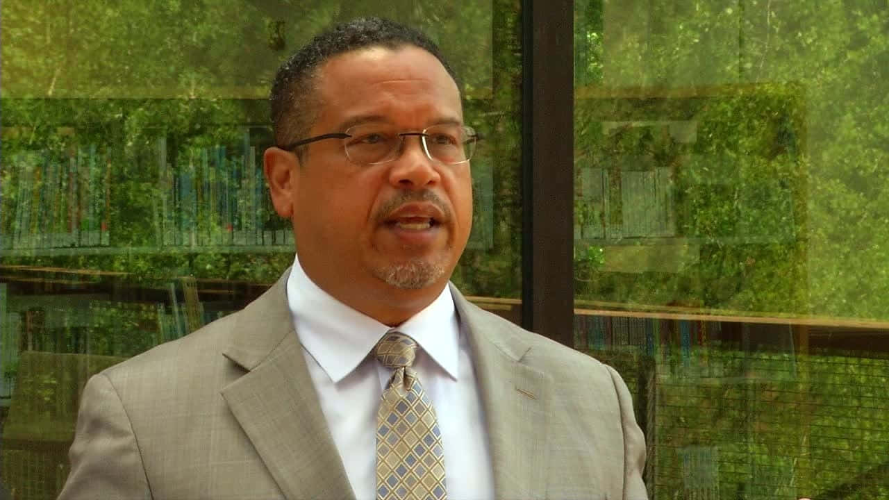 Keith Ellison With Green Glass Windows Wallpaper
