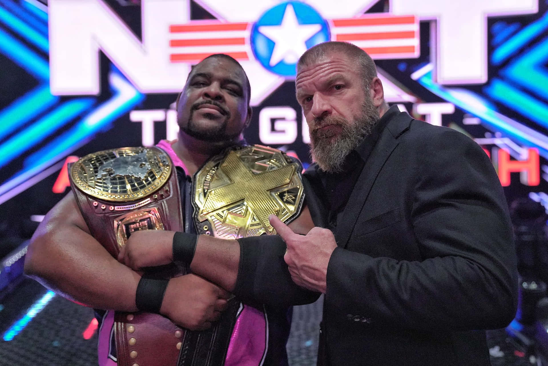 Keith Lee And Triple H NXT Champion Belts Wallpaper