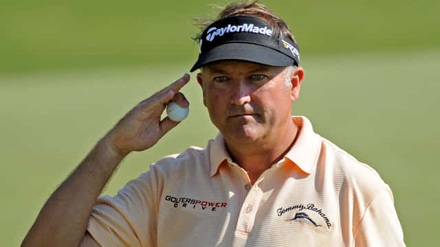 Professional Golfer Ken Duke Salutes with a Golf Ball Wallpaper