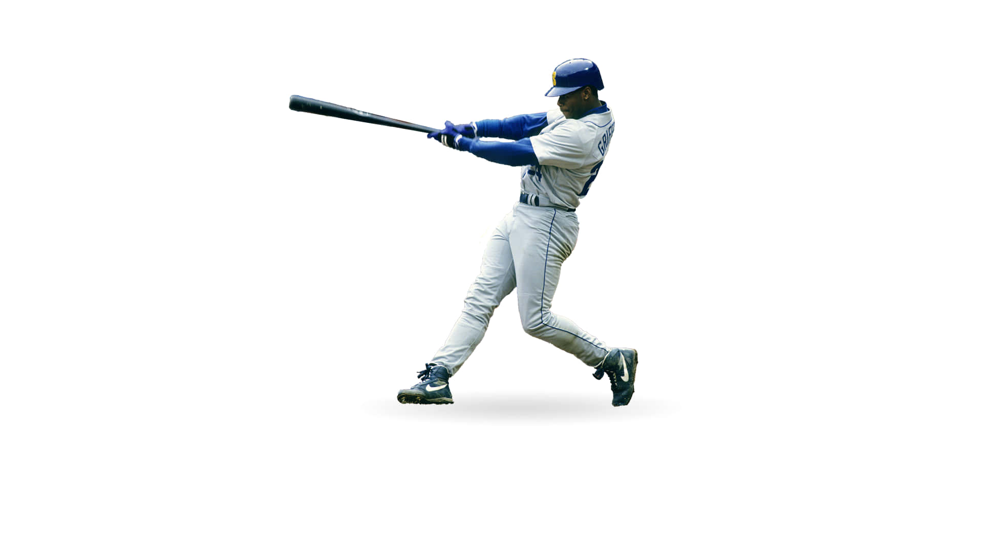 Legendary baseball player Ken Griffey Jr is pictured swinging a bat. Wallpaper