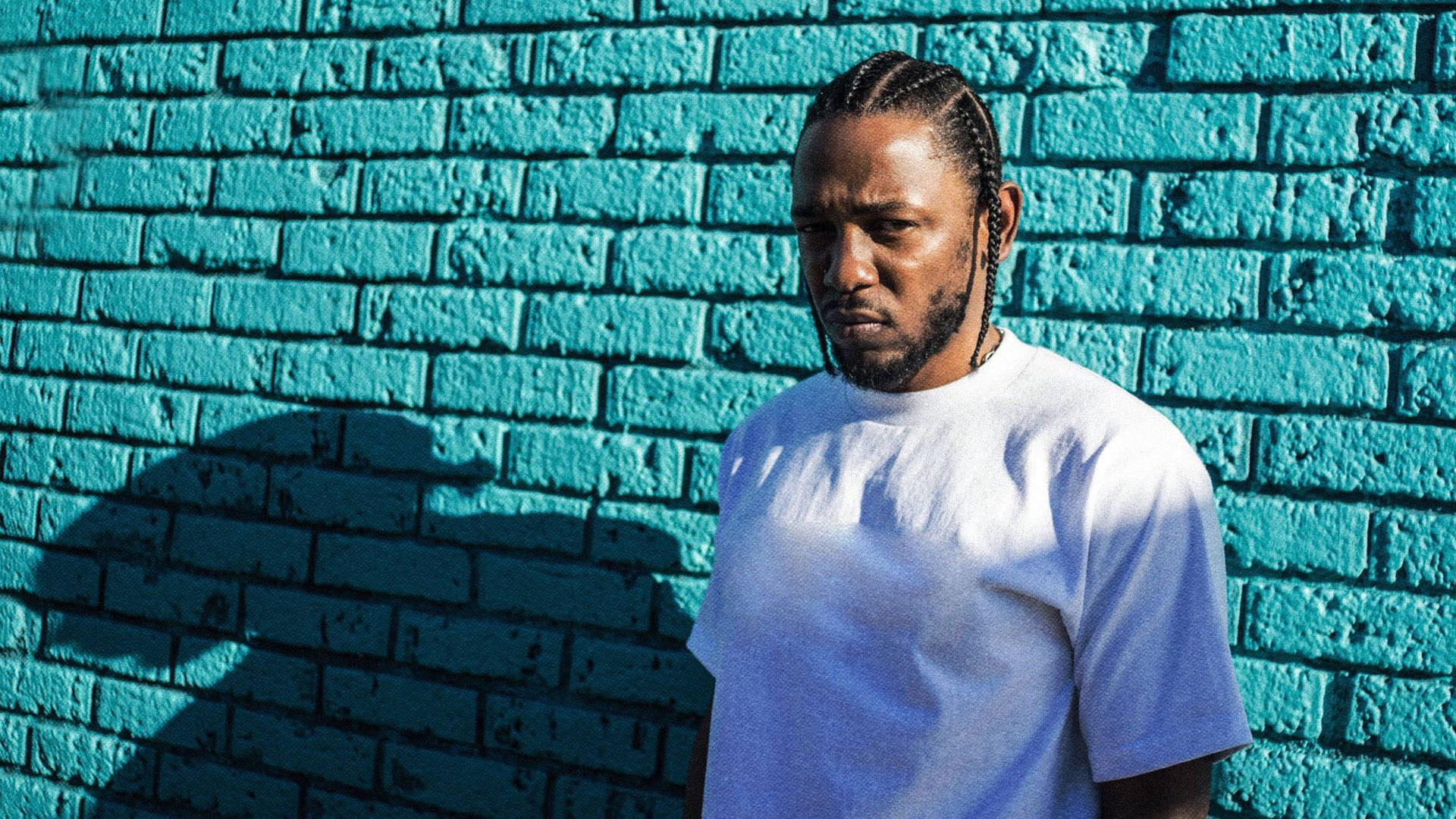 Kendrick Lamar On Blue Brick Wall Wallpaper