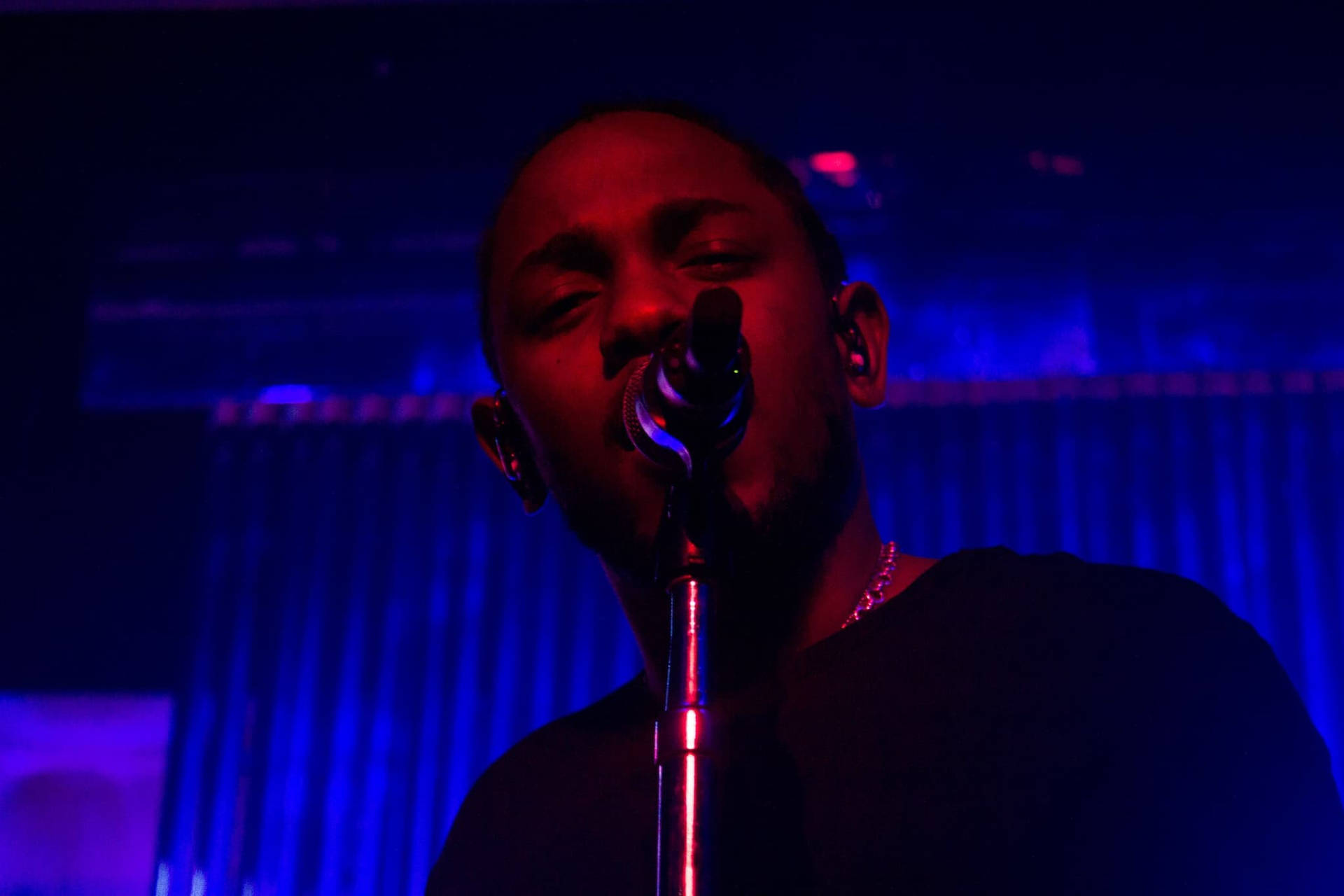 Kendrick Lamar With Mic Onstage Wallpaper