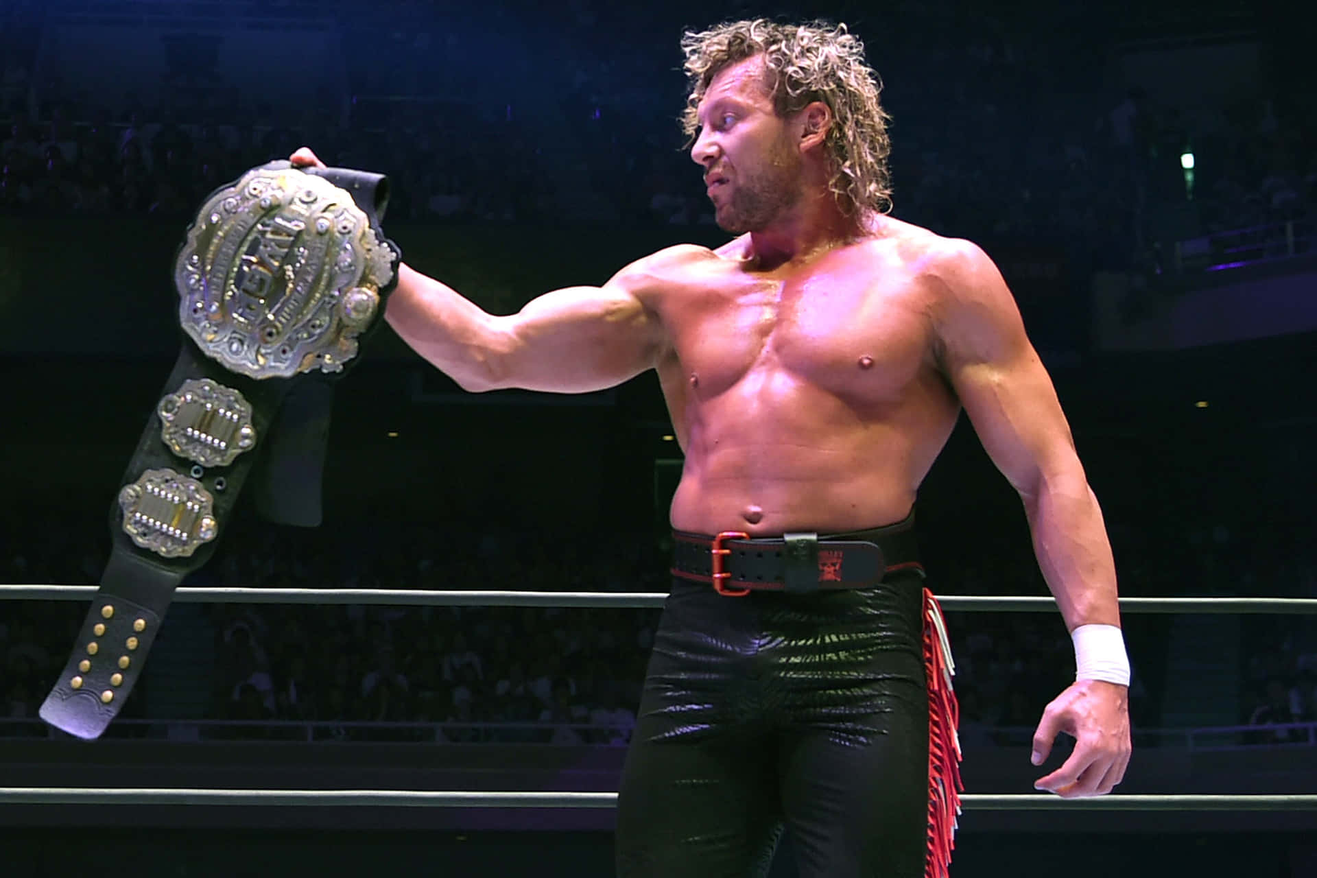 Kenny Omega Looking At His Championship Belt Background