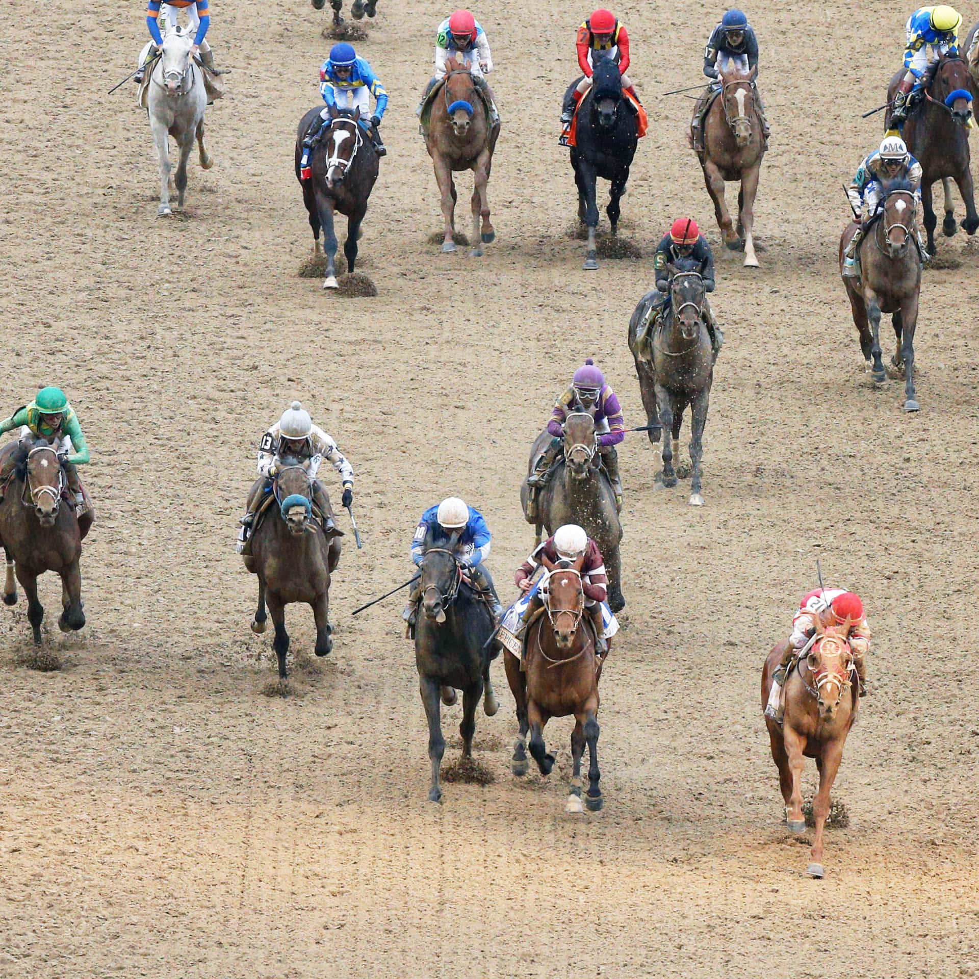 A Group Of Jockeys Riding Horses On A Dirty Track