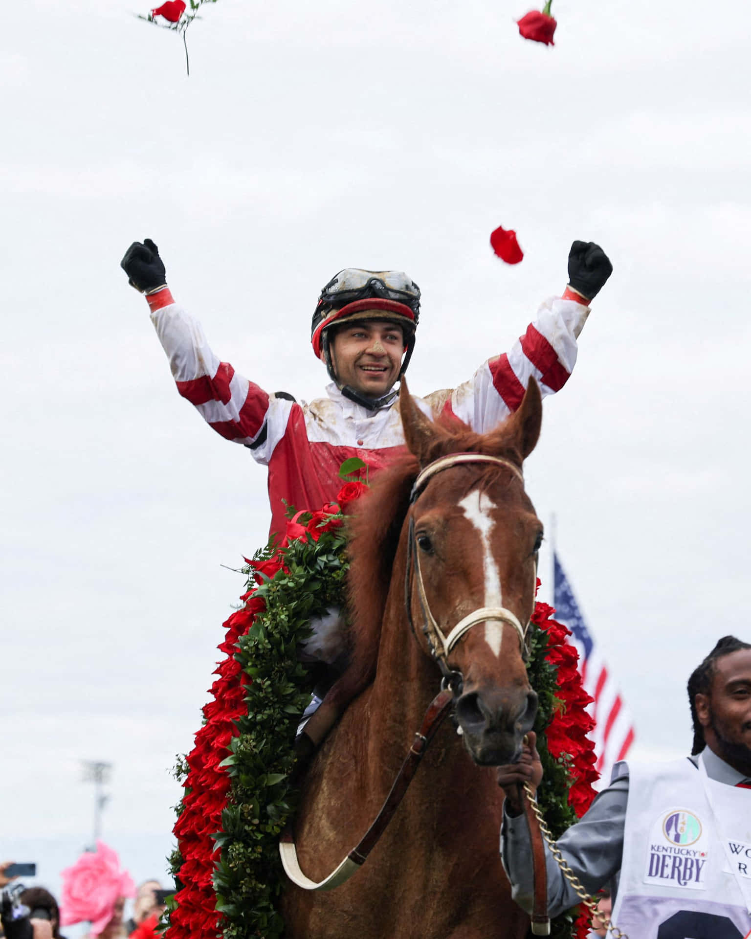 A Jockey On A Horse With Flowers On His Head