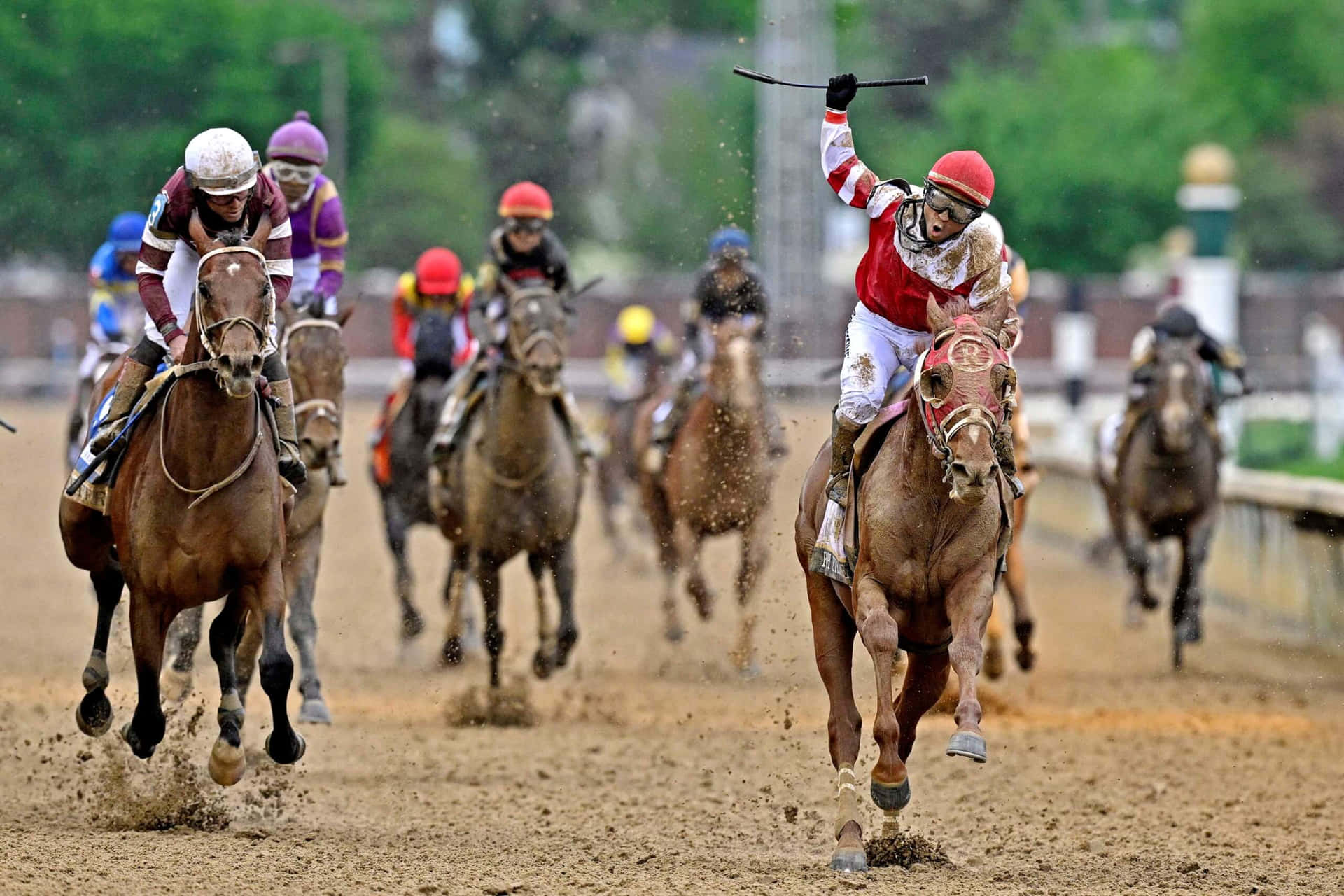 A Group Of Jockeys Are Racing On Horses