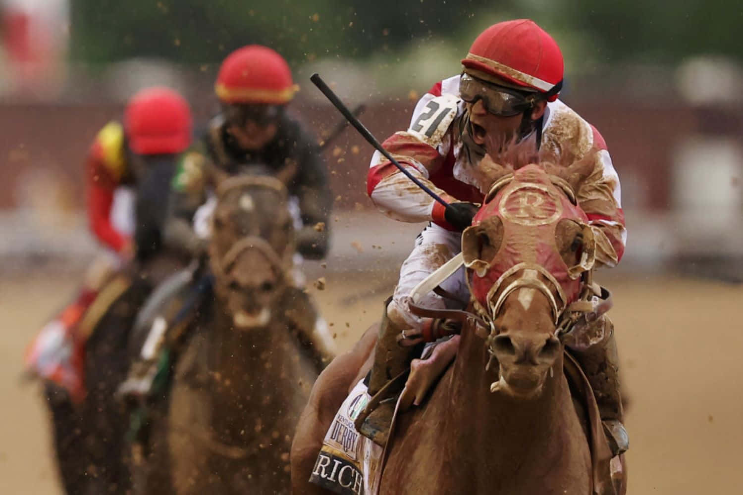 A Jockey Is Riding A Horse On A Dirt Track