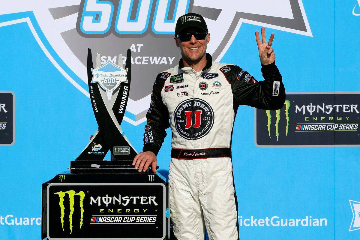 Kevin Harvick Posing with His Championship Trophy Wallpaper
