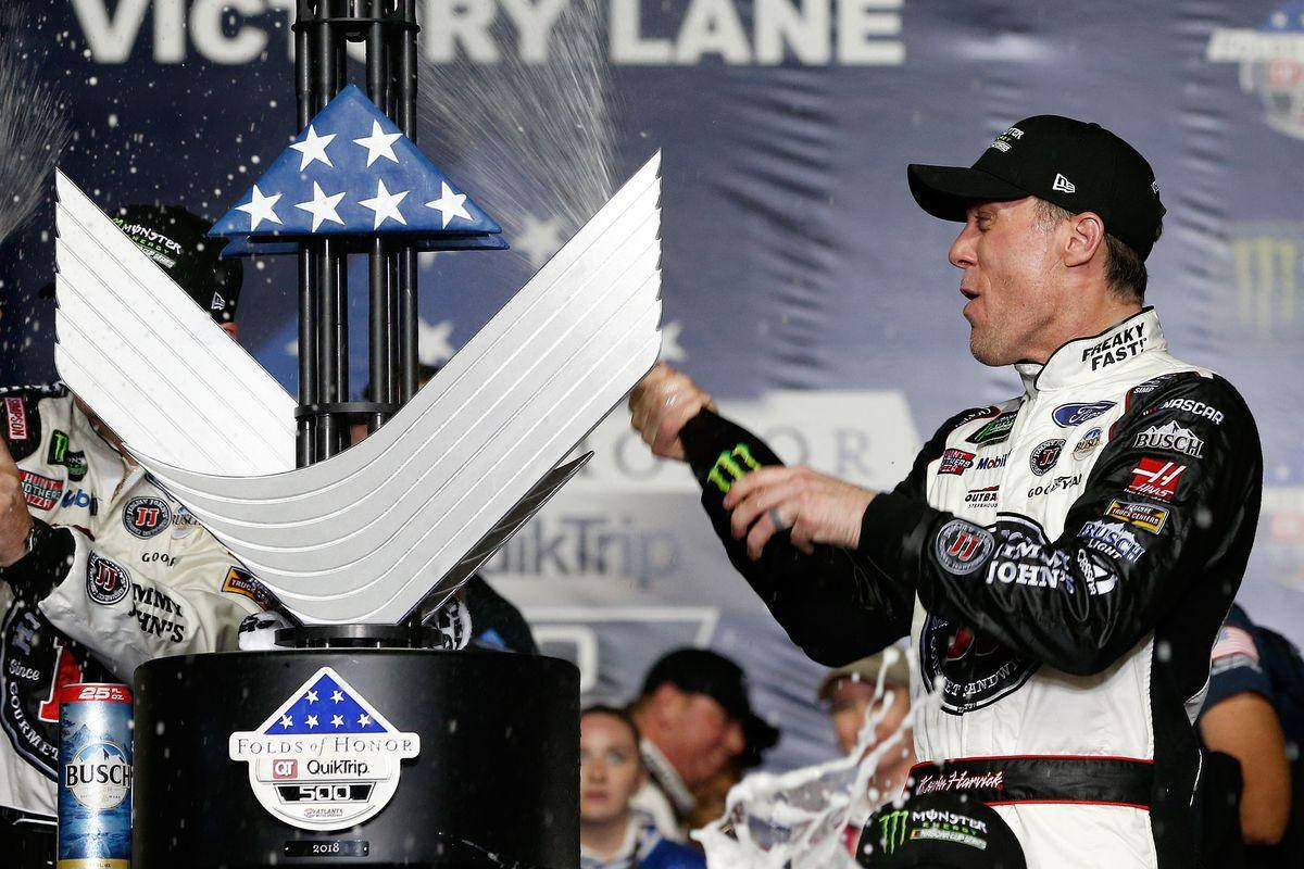 NASCAR Racer Kevin Harvick Celebrating Victory with Champagne Splash. Wallpaper