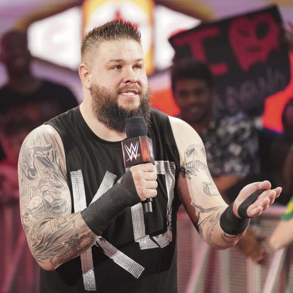Kevin Owens striking a pose during a live event Wallpaper