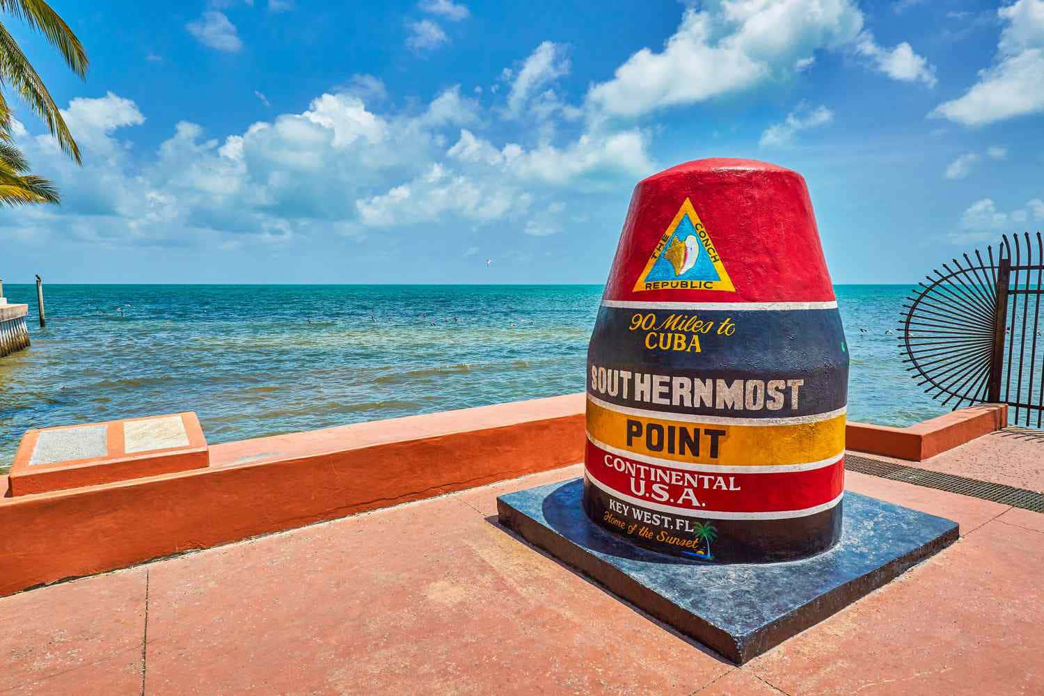 A Colorful Monument Is In Front Of The Ocean