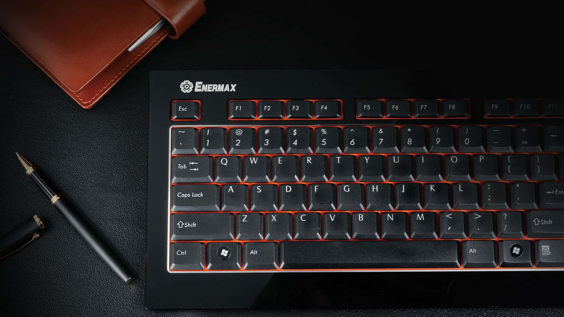 A Black Keyboard With A Red And Black Mouse
