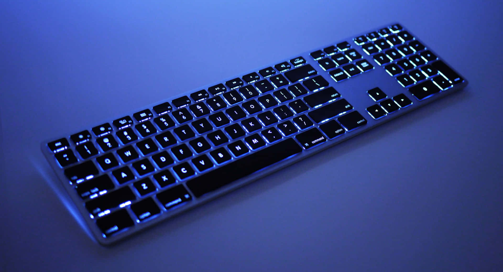 A Keyboard With Blue Lights On It