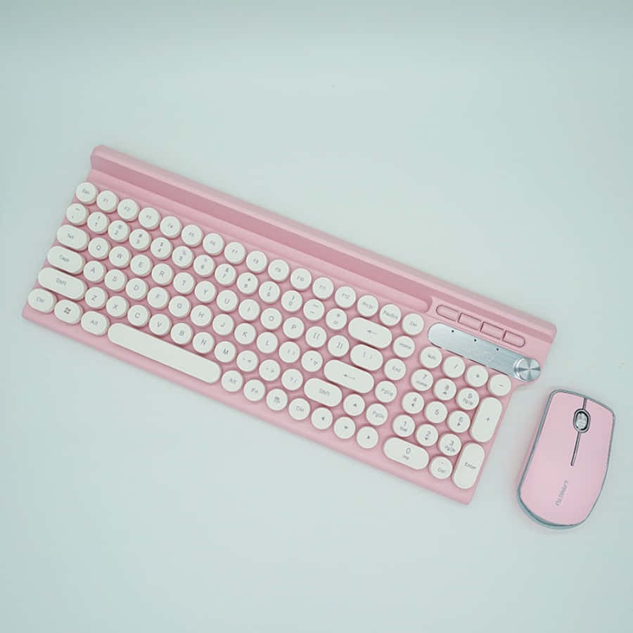 A Pink Keyboard And Mouse On A White Surface