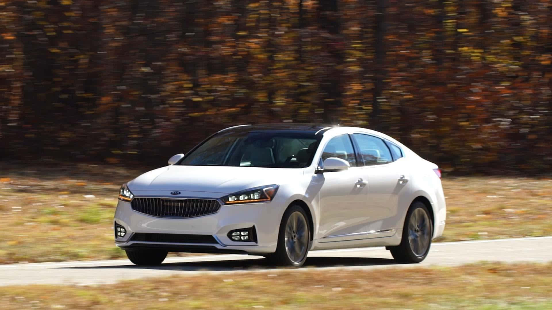 Luxurious Kia Cadenza cruising on the road. Wallpaper