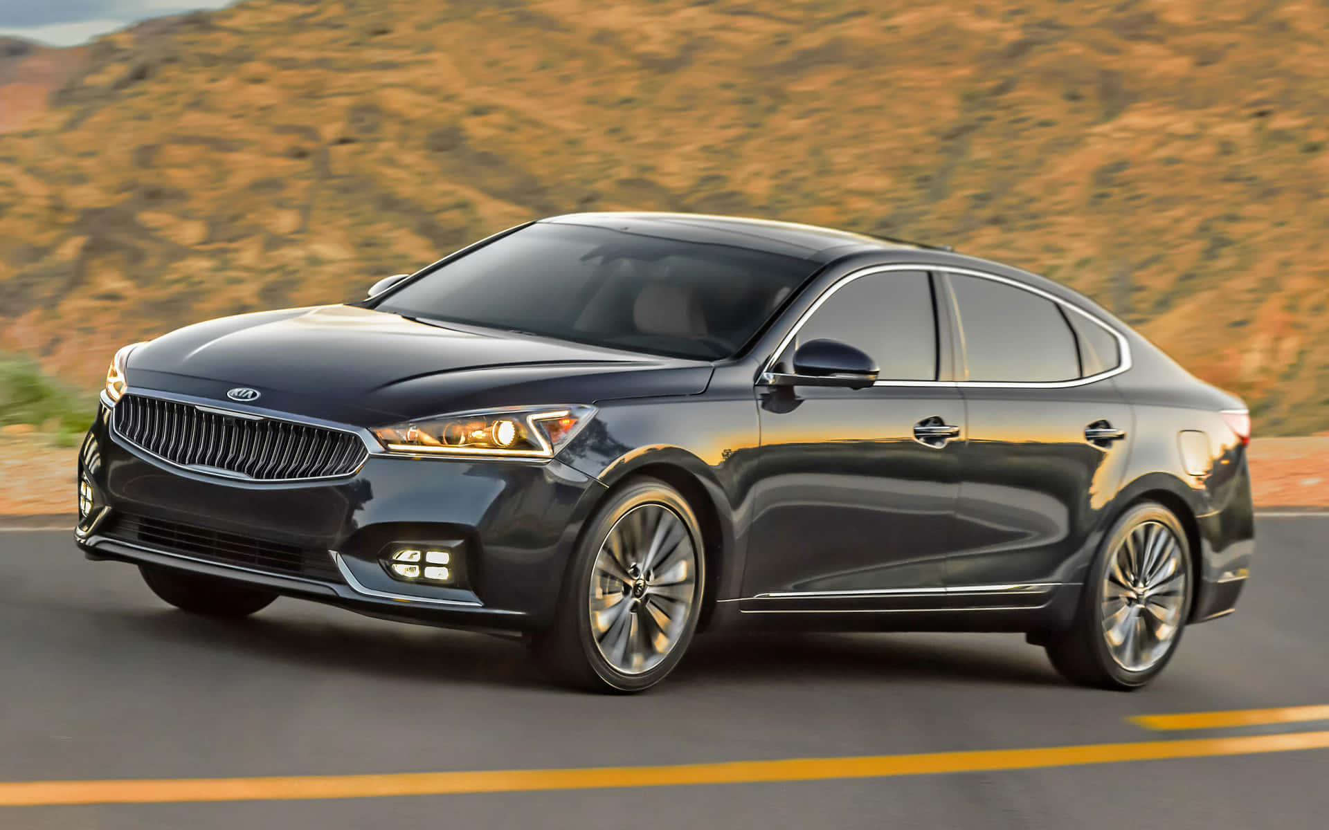 Sleek Kia Cadenza Cruising on the Highway Wallpaper