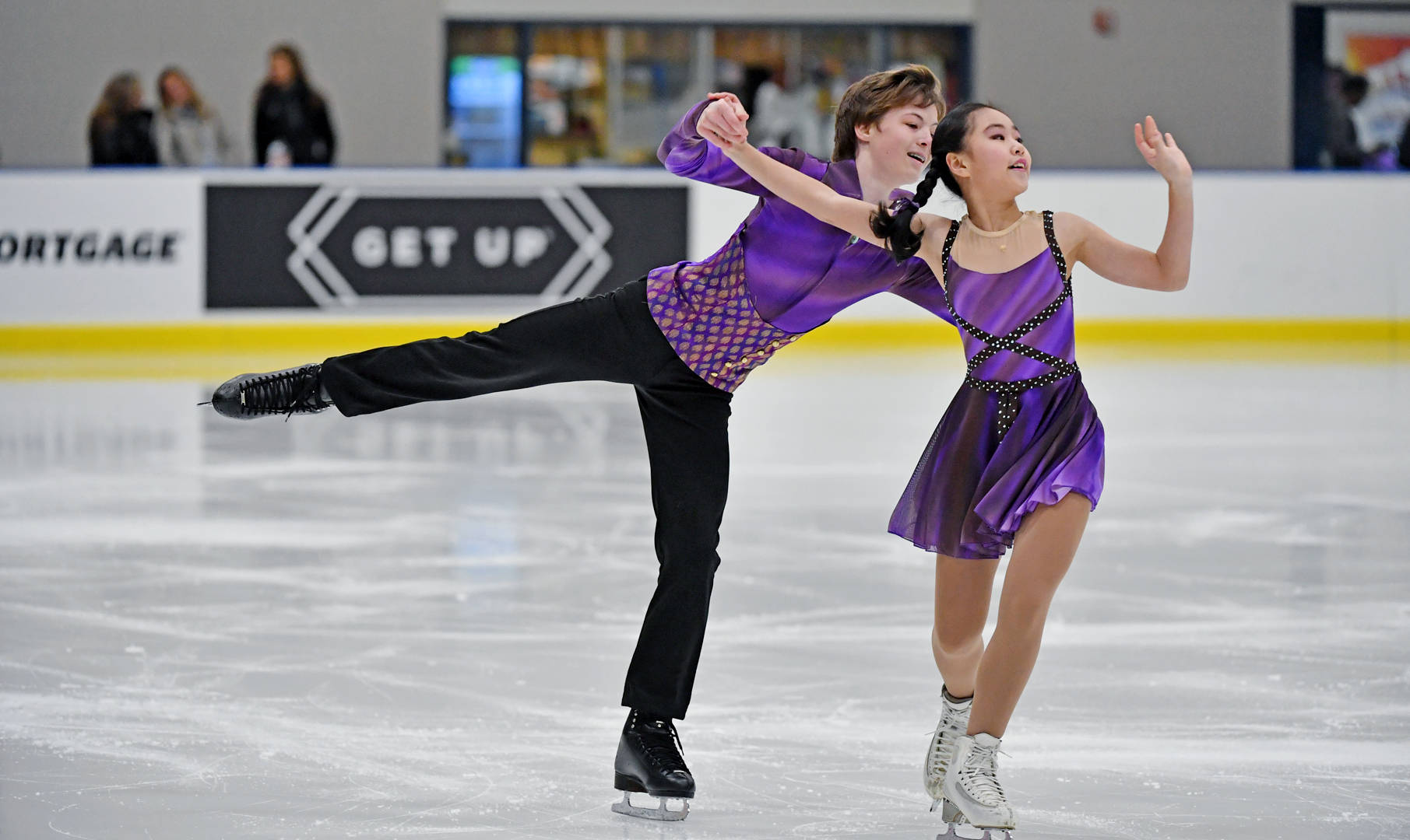 Kiana Pan and llya Mondrowski in mid-performance at juvenile figure skating Wallpaper