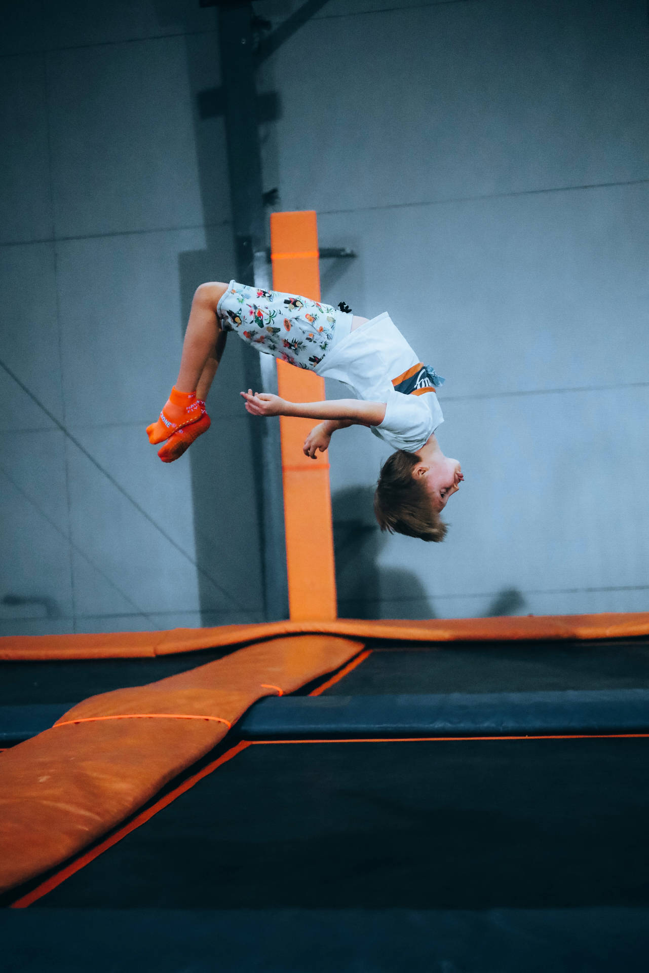 Kid Flip Jumping On A Trampoline Wallpaper