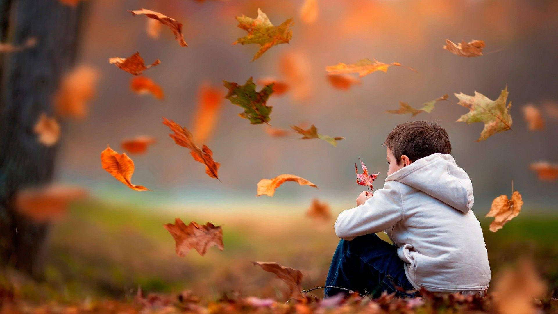 "A child finds joy in the windy Autumn season". Wallpaper