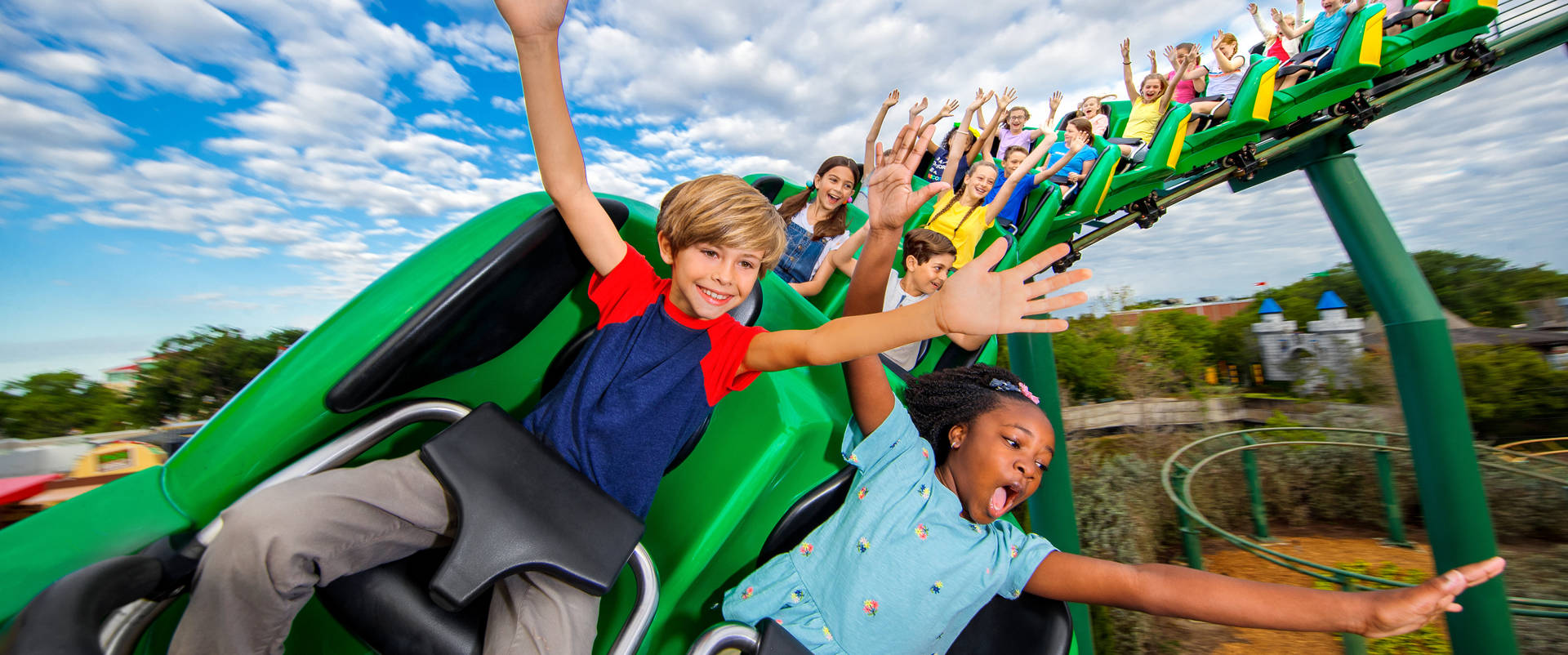 Kids Enjoying Rollercoaster At Legoland Wallpaper
