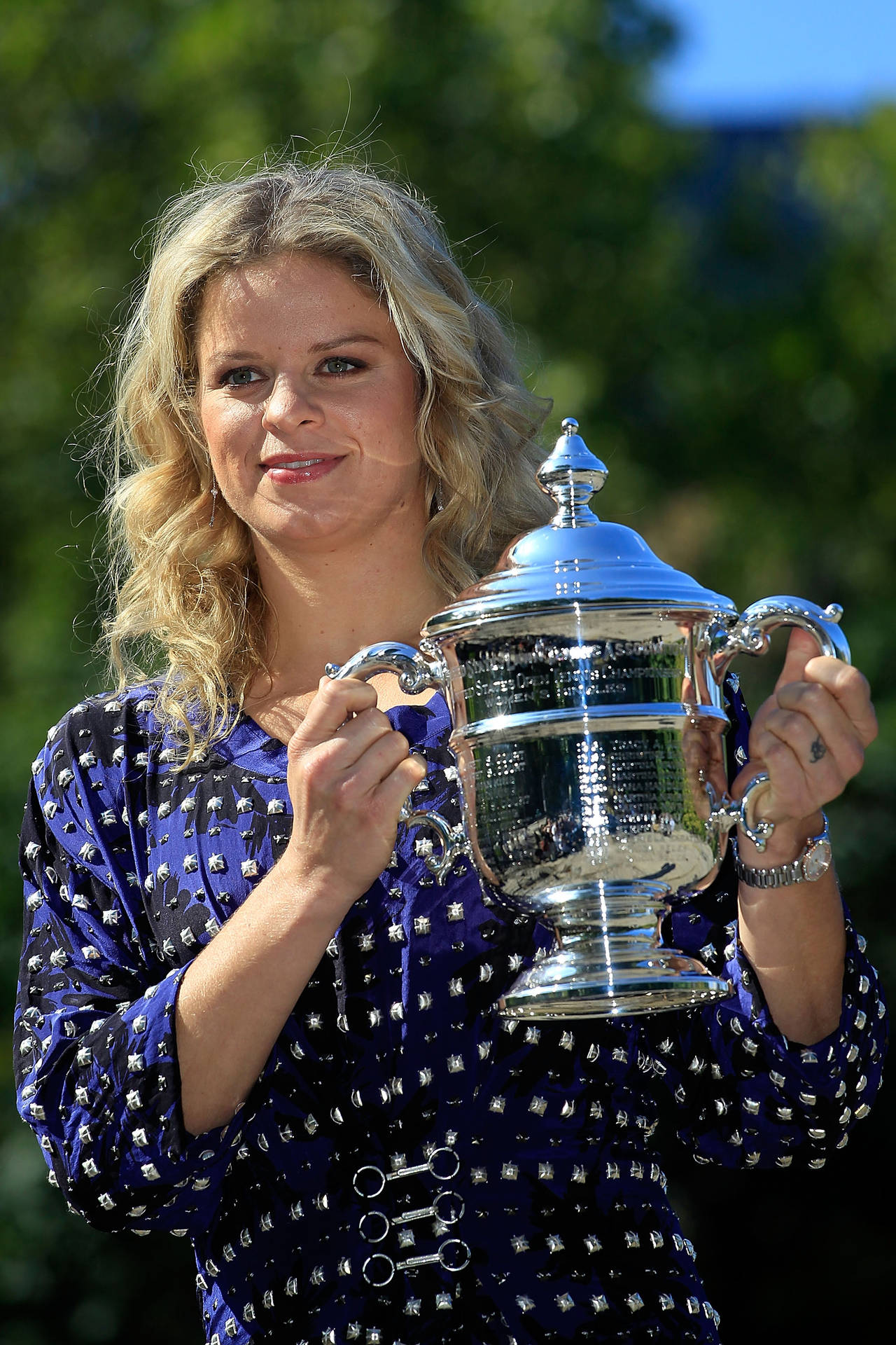 Kim Clijsters Triumphantly Holding Silver Trophy Wallpaper