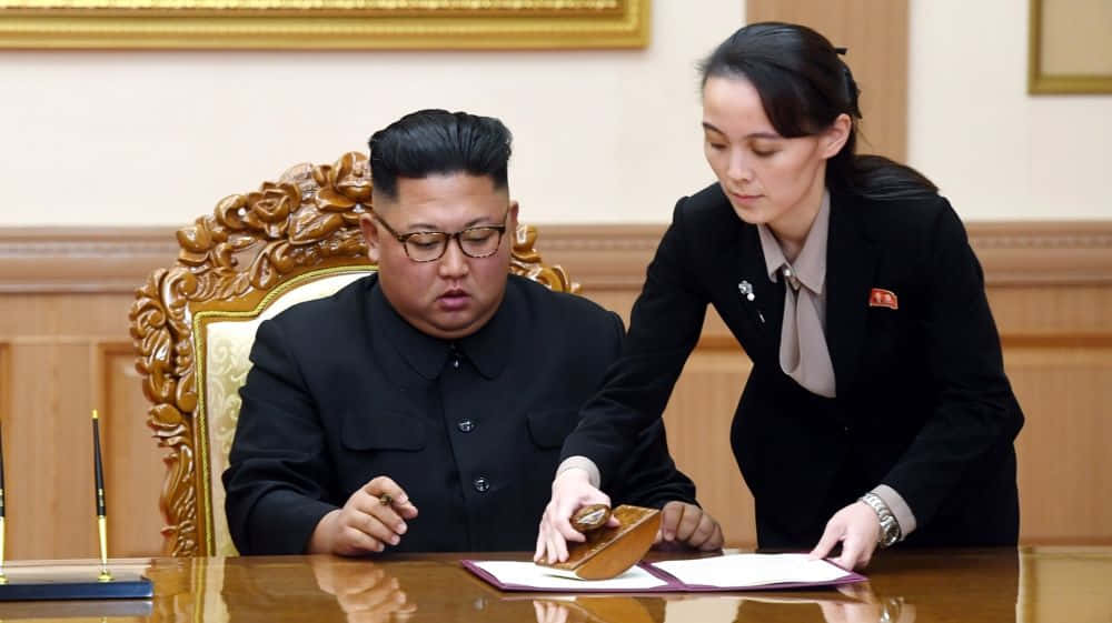 Kim Jong Il And A Woman Signing A Document