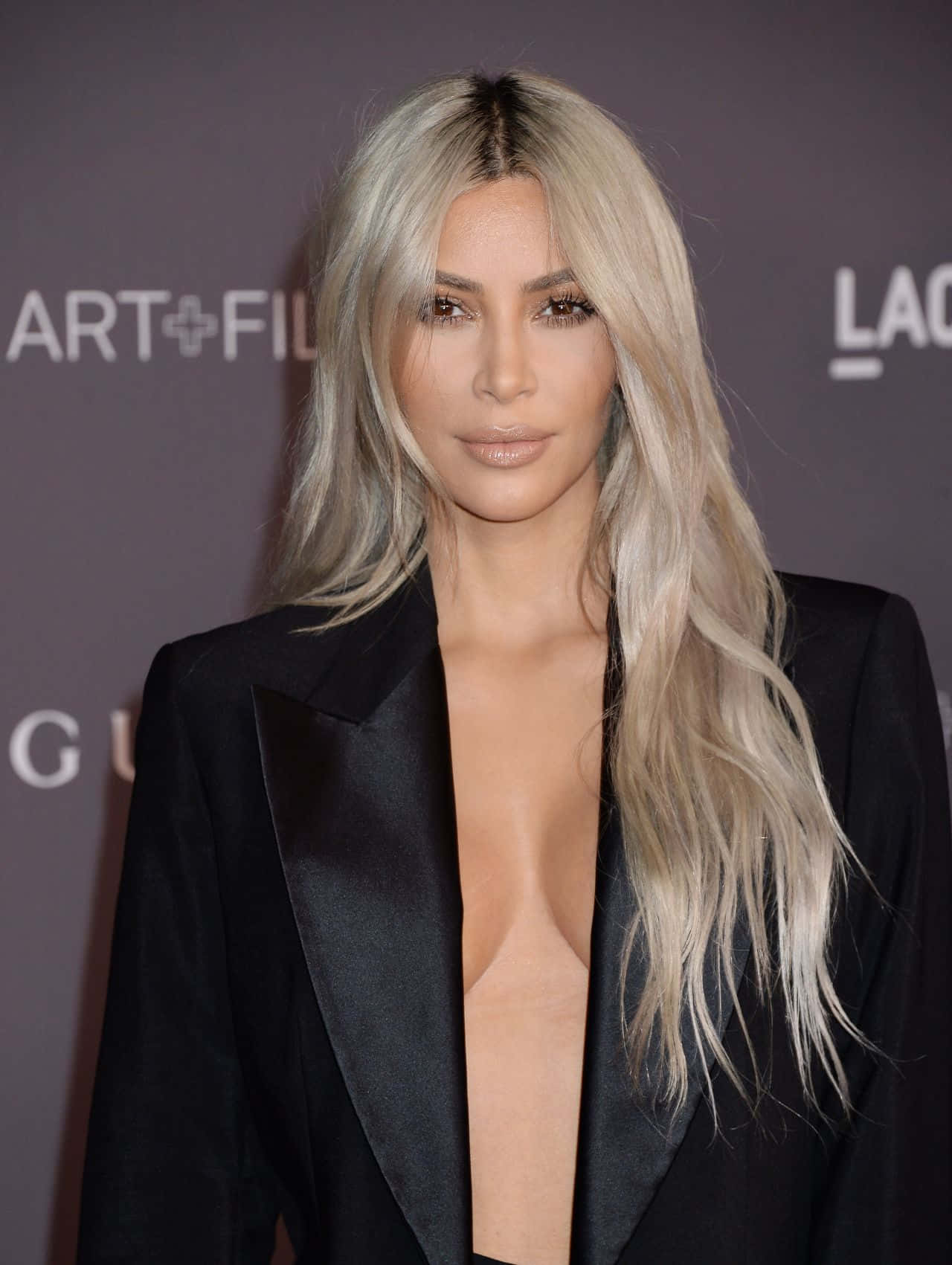 Kim Kardashian looking glam in a white dress.