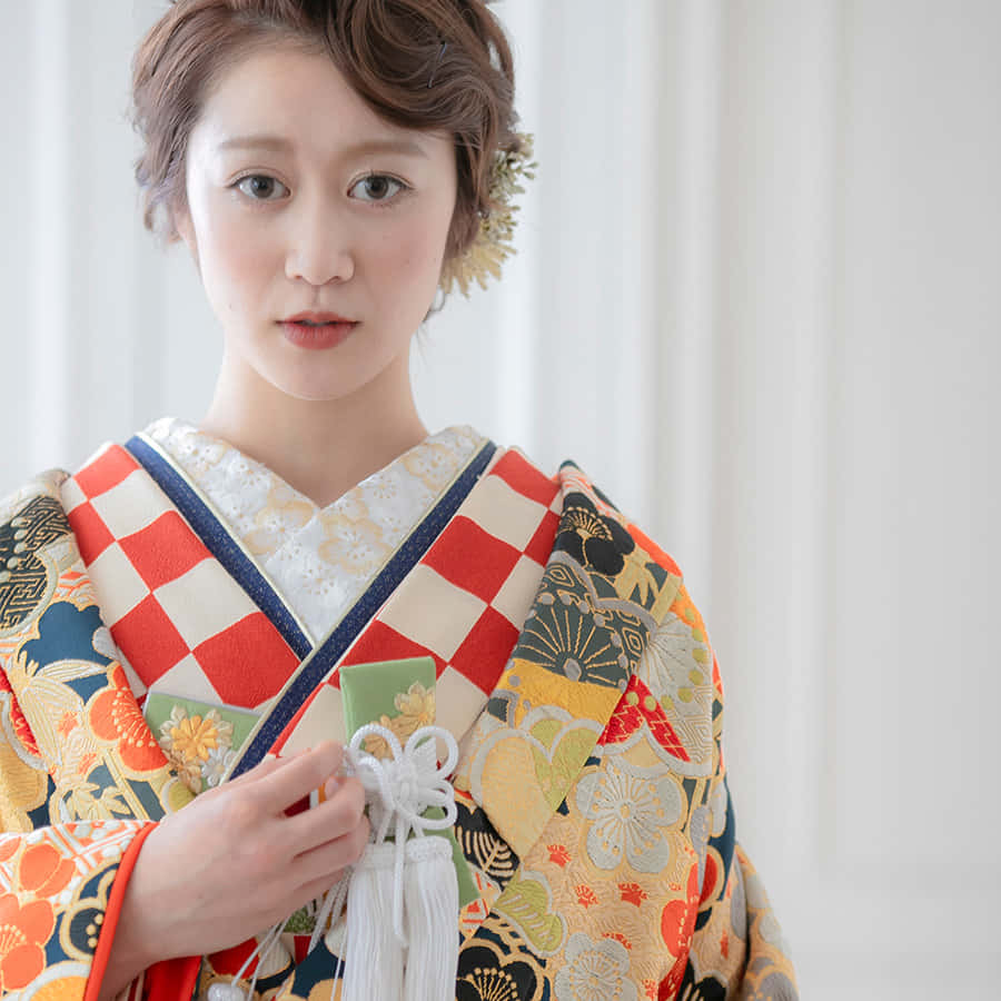 A Woman In A Kimono Is Posing For A Picture