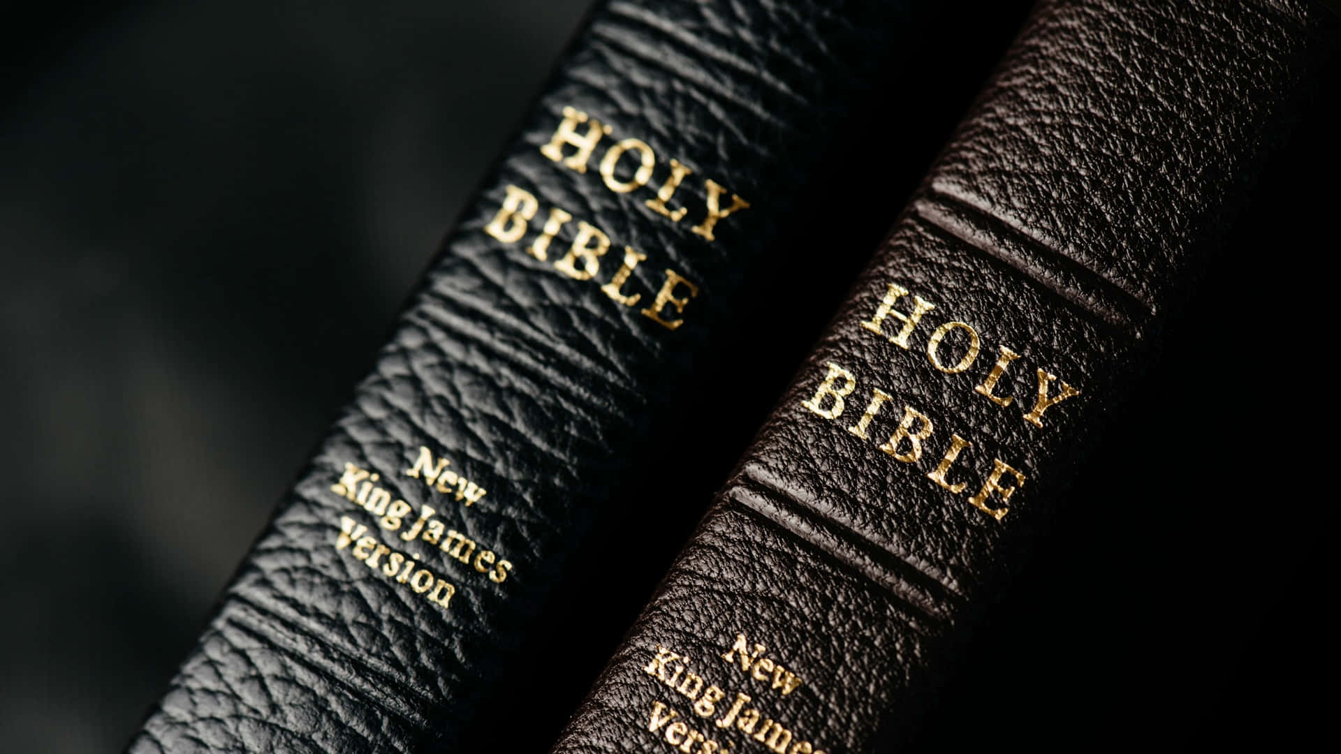 Two Bibles With The Word Holy On Them Wallpaper