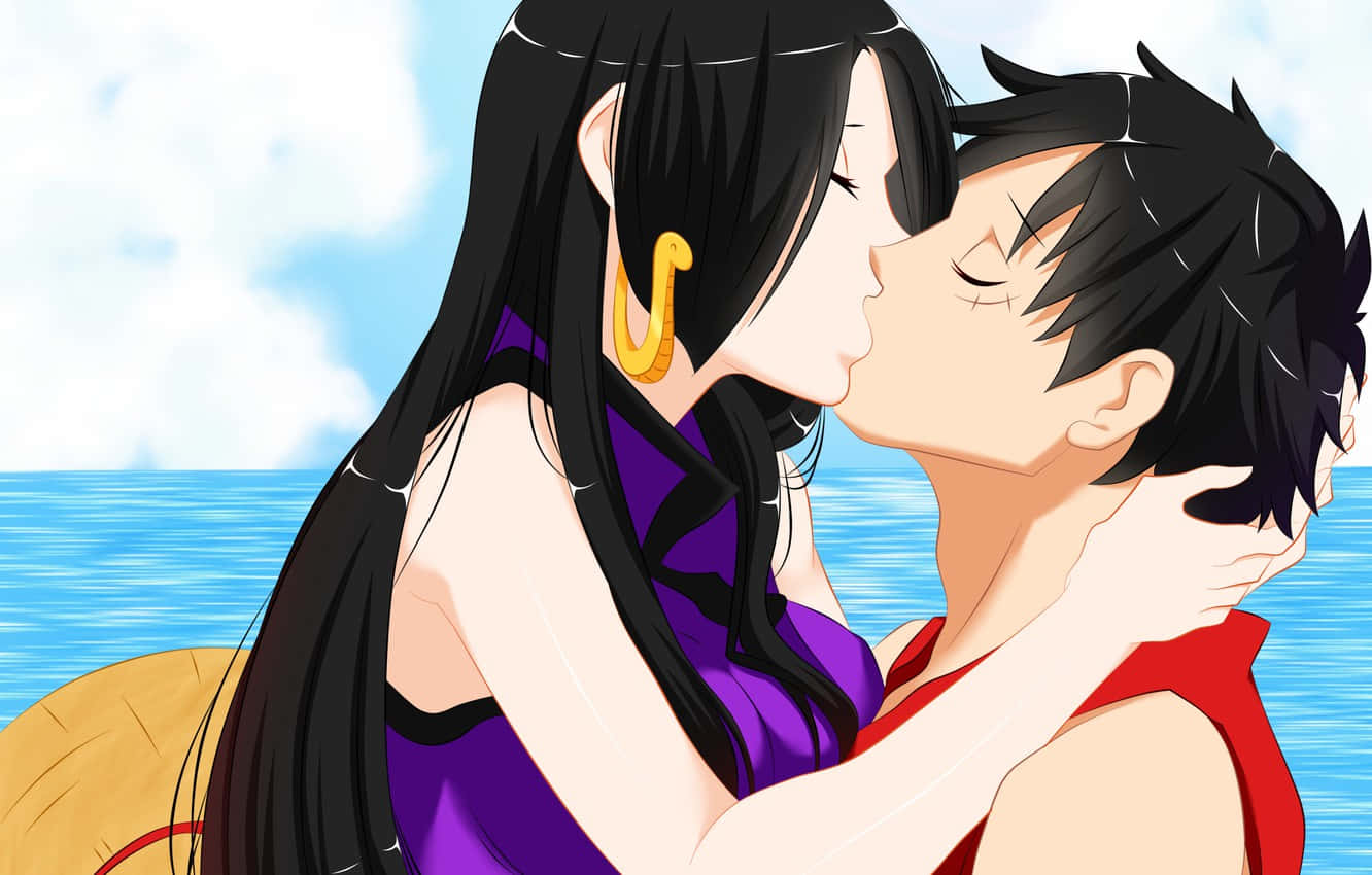 A Couple Kissing In Front Of The Ocean Wallpaper