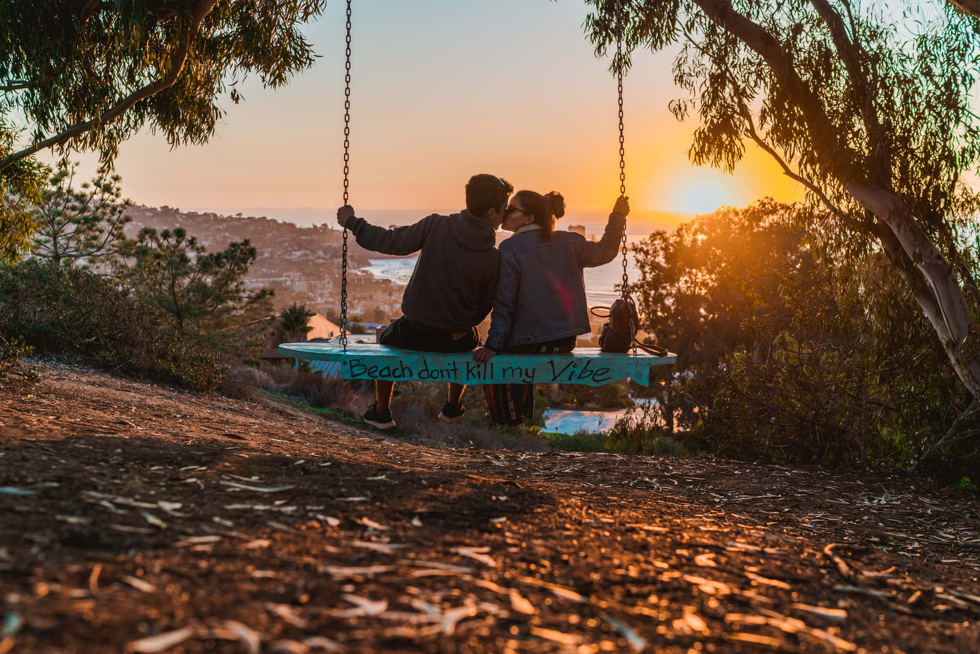 couple on swing at sunset