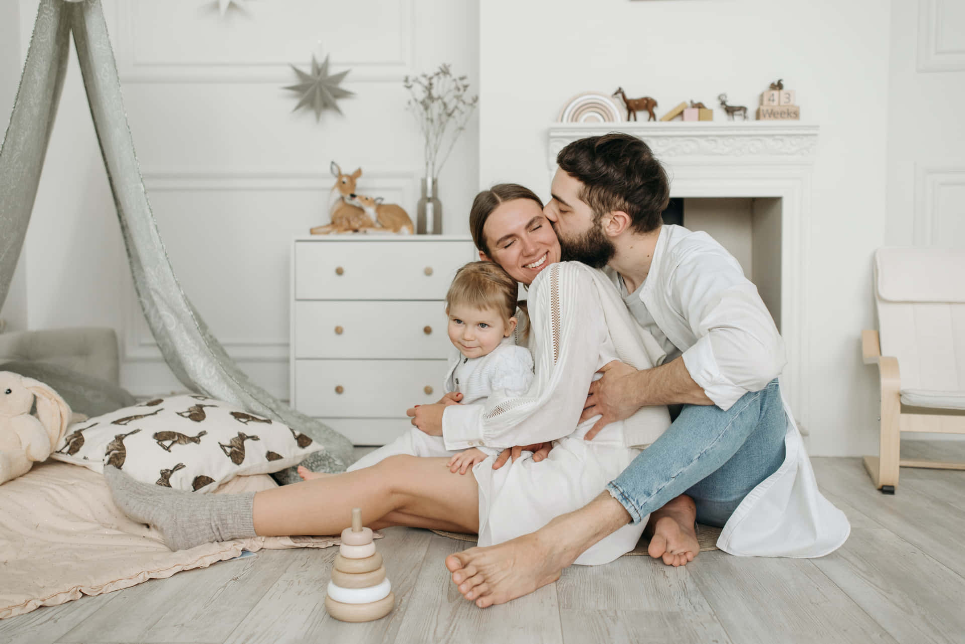 Happy Family With Baby In White Room