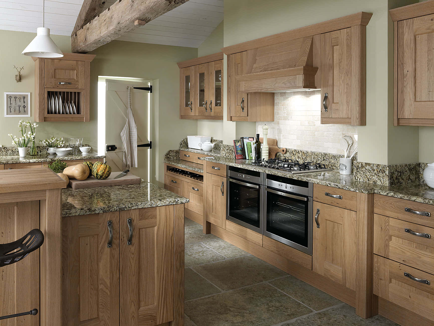 A Kitchen With Wooden Cabinets And Granite Counter Tops