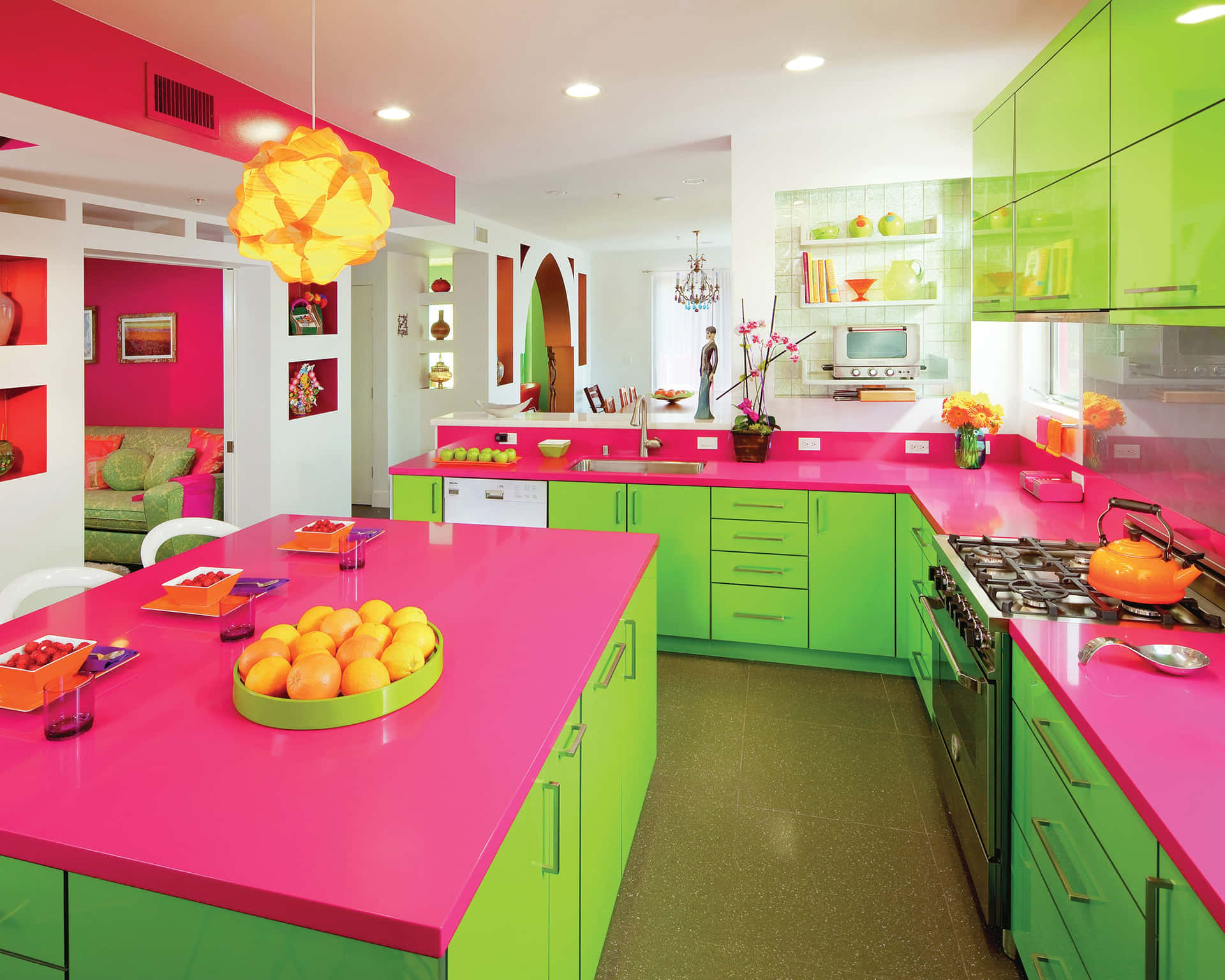 A Kitchen With Bright Pink And Green Cabinets