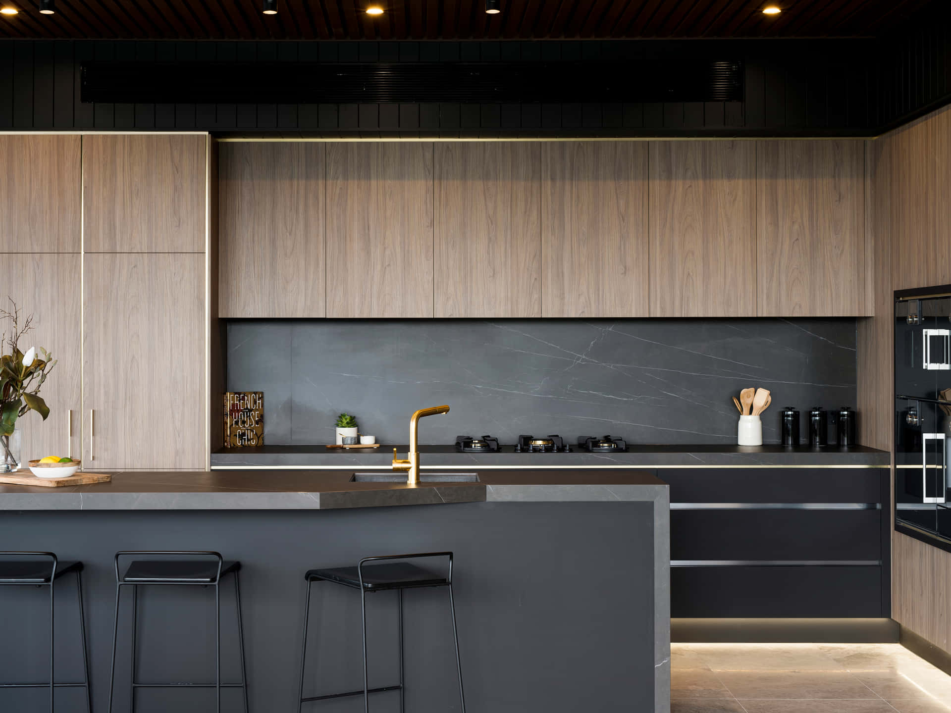 A Modern Kitchen With Black Cabinets And Black Counter Tops