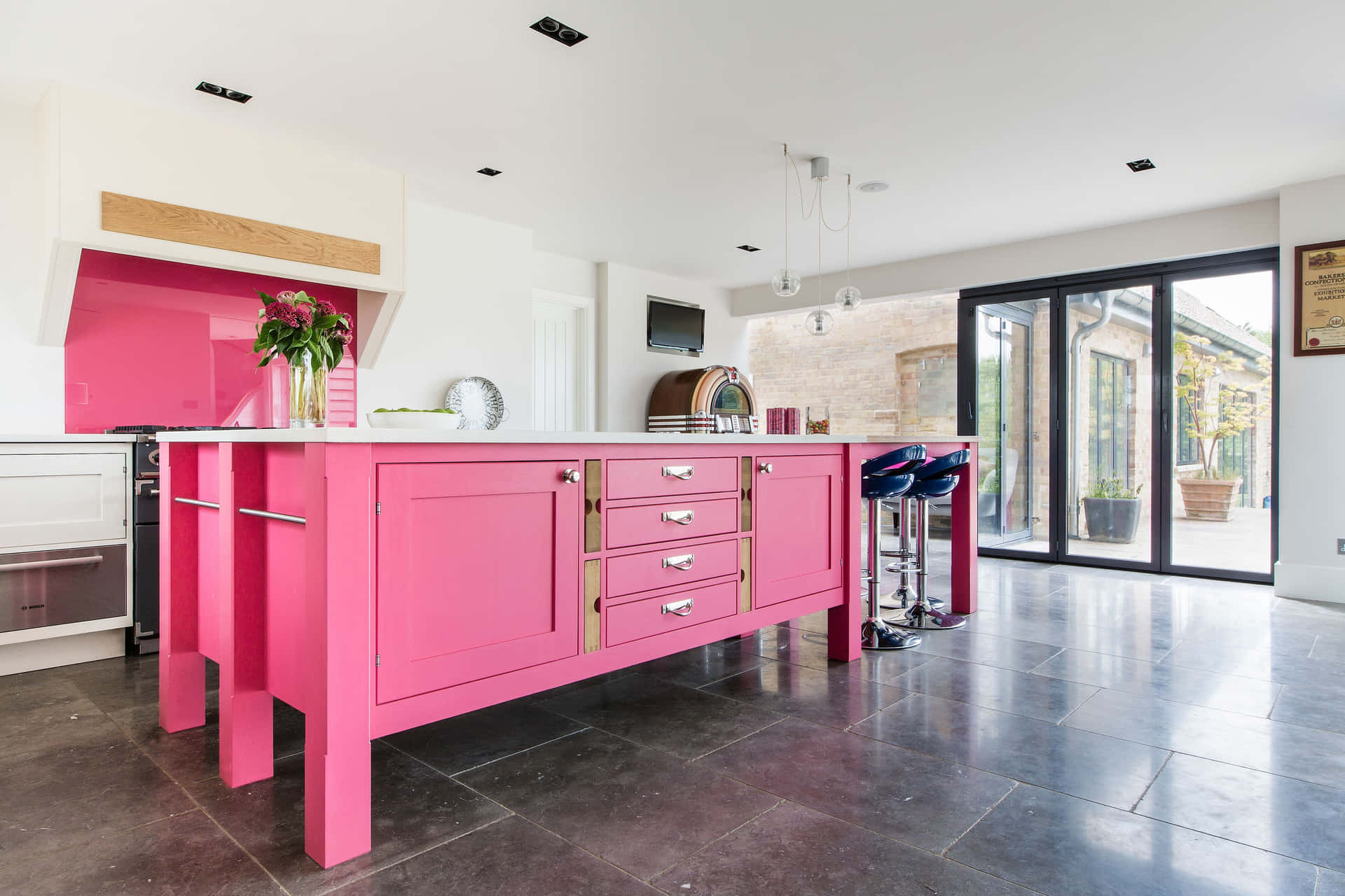 A Kitchen With A Pink Island