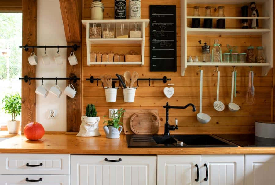 A Kitchen With Wooden Cabinets And Shelves