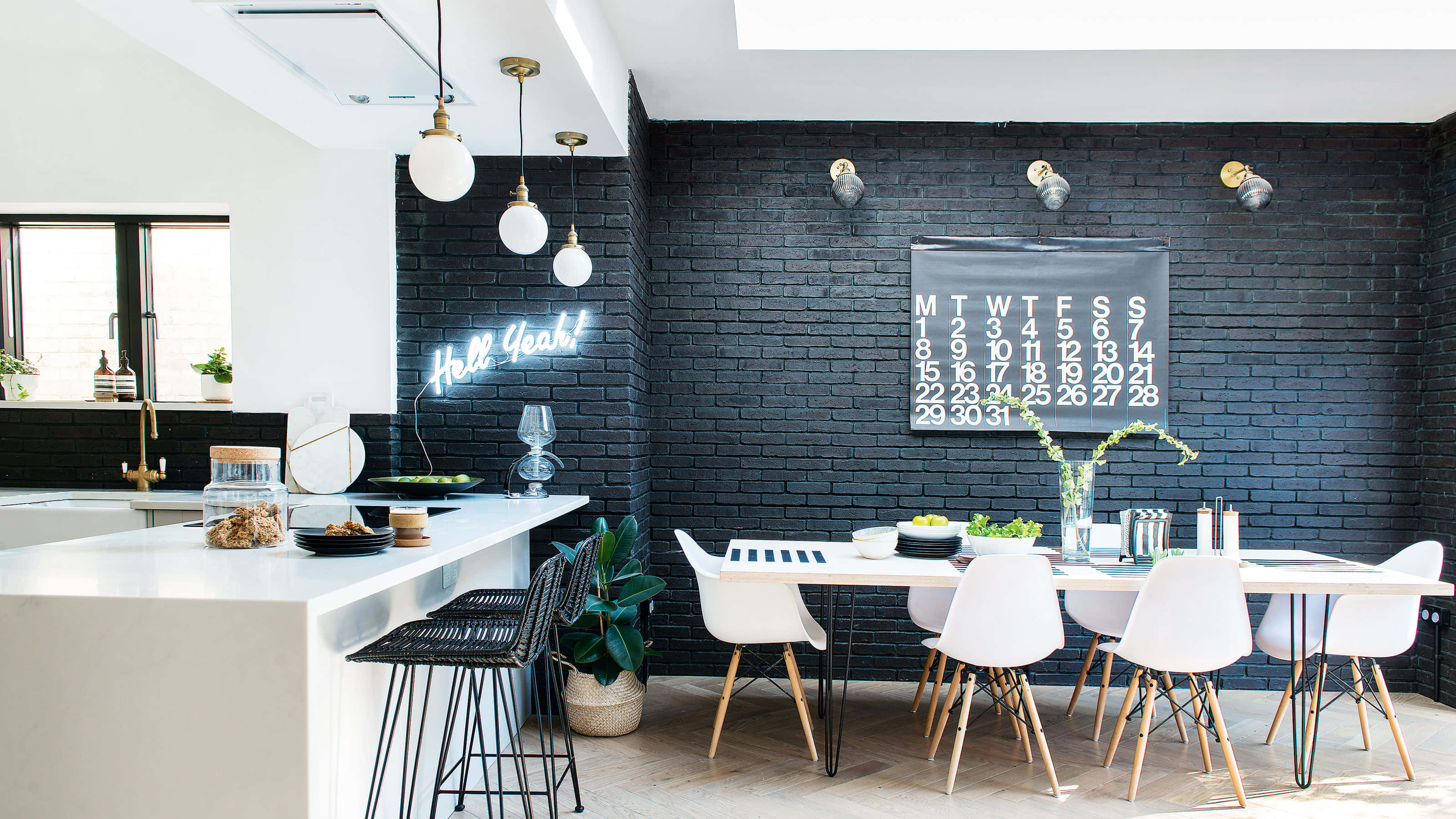 A Black Kitchen With White Chairs And A White Table