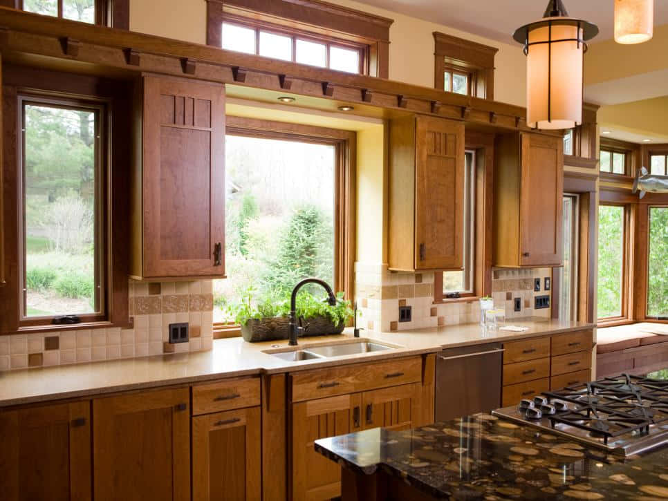 A Kitchen With A Large Window And Wooden Cabinets