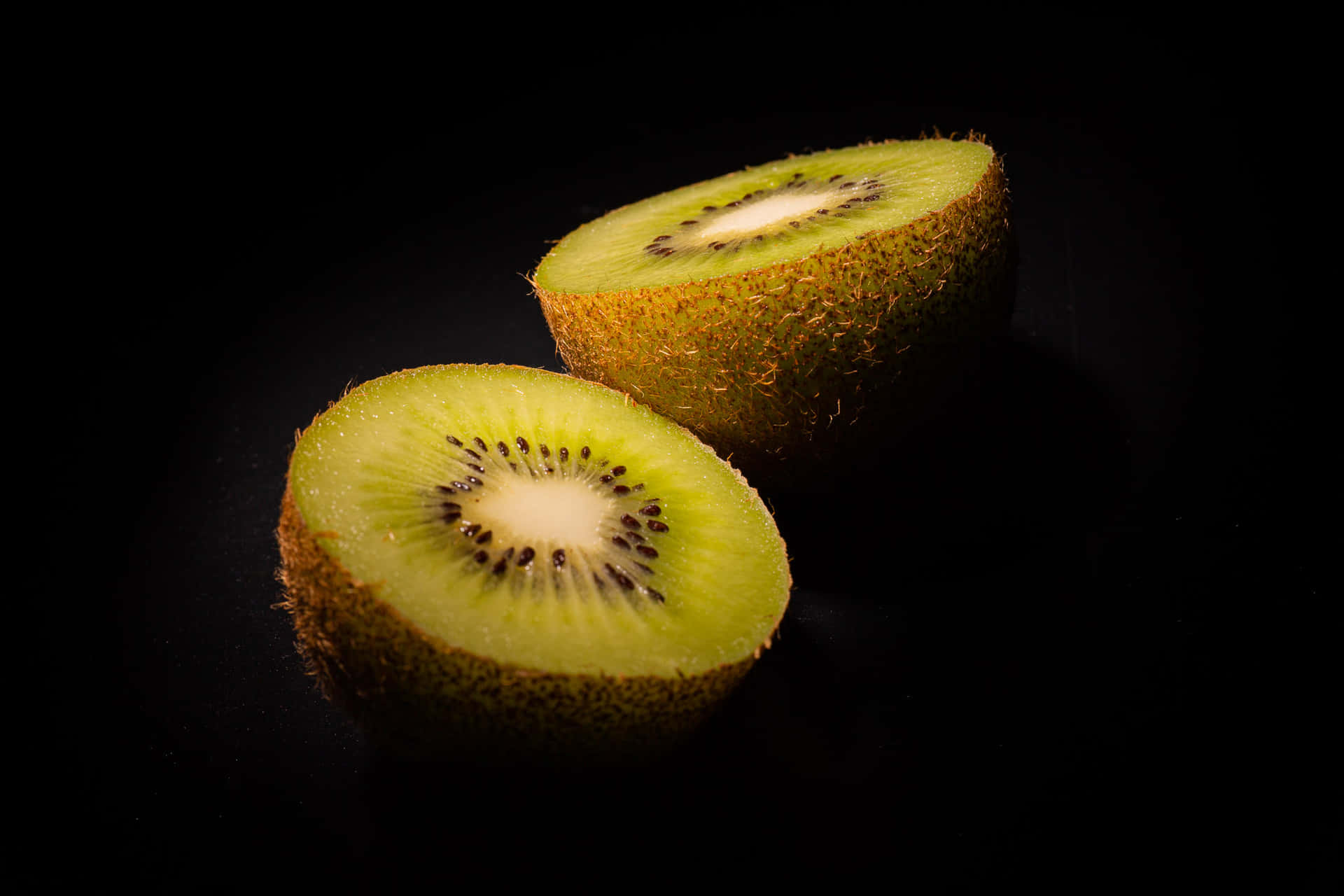 A close-up of a vibrant green kiwi fruit sliced in half