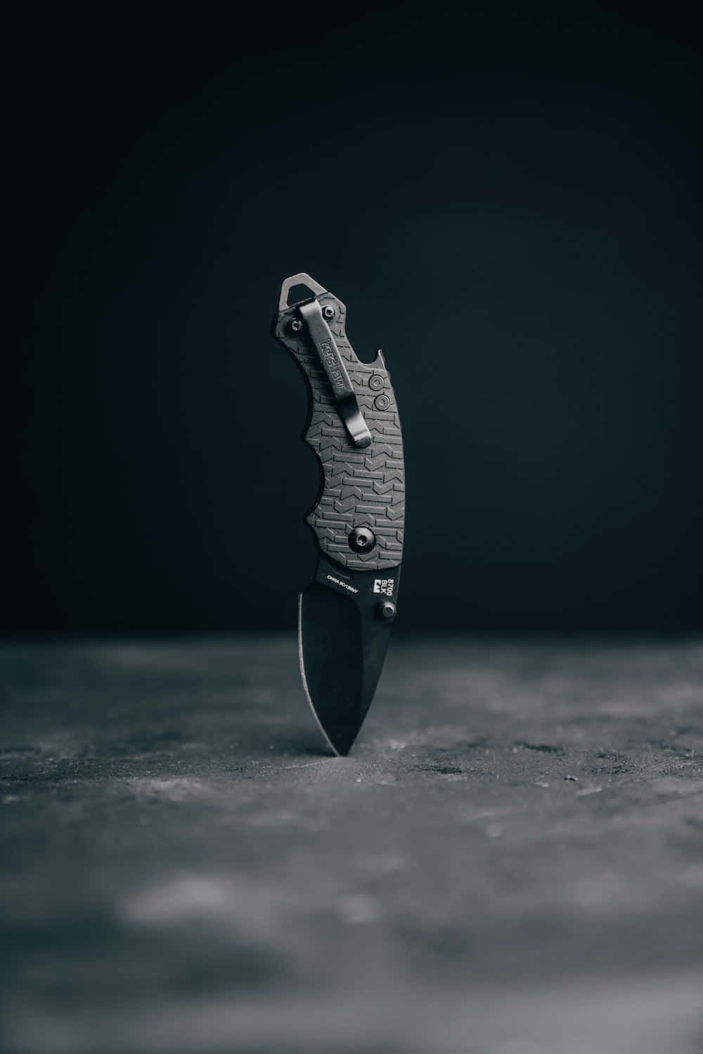 A Knife Is Sitting On A Table With A Black Background