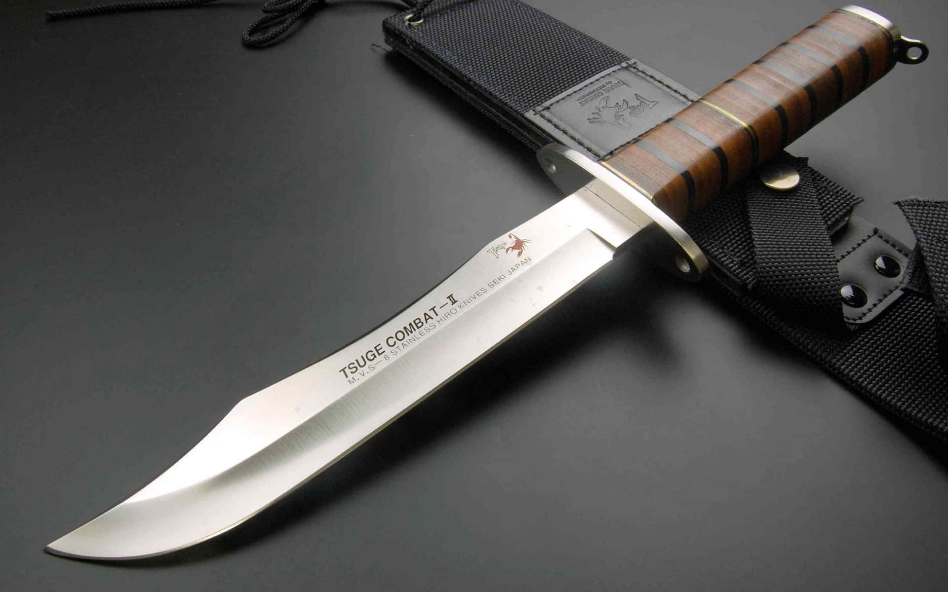 A Knife With A Wooden Handle On A Black Surface