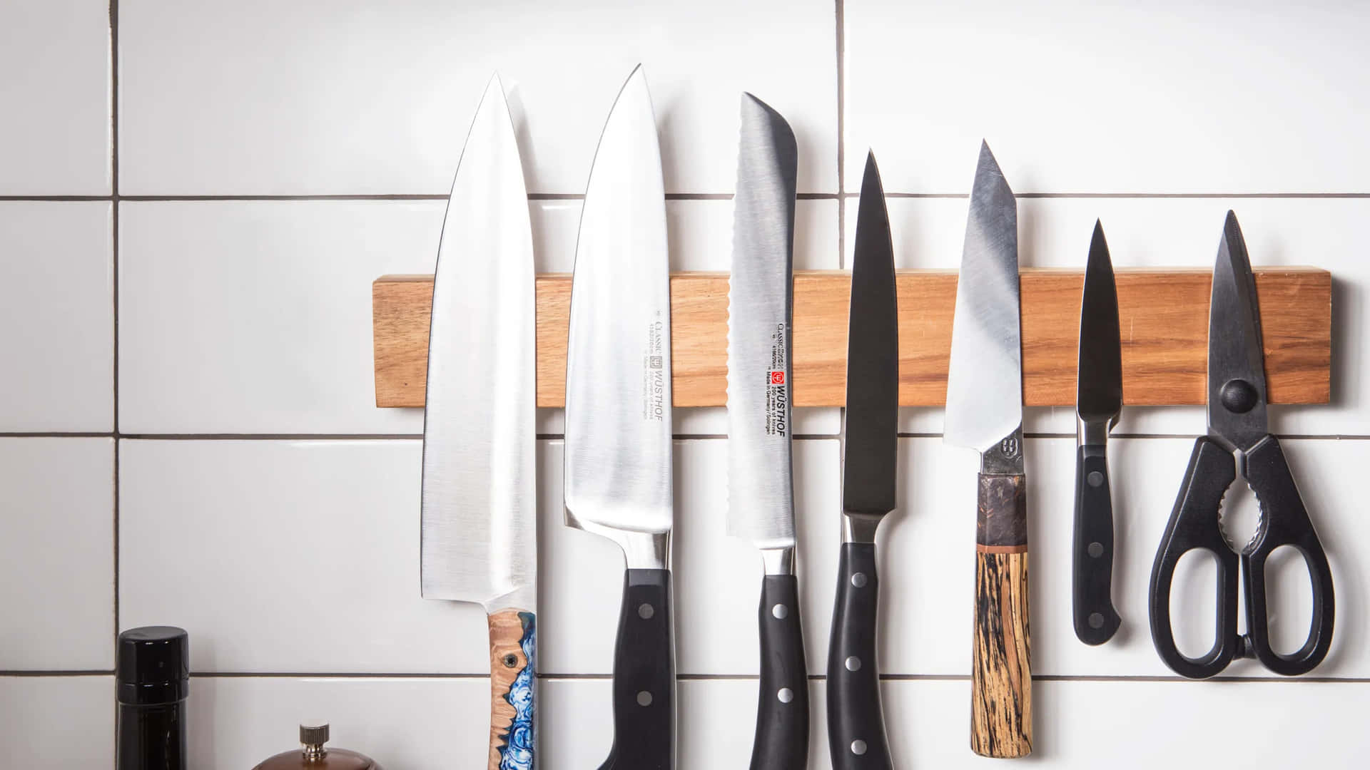 A Kitchen With Knives Hanging On A Wall