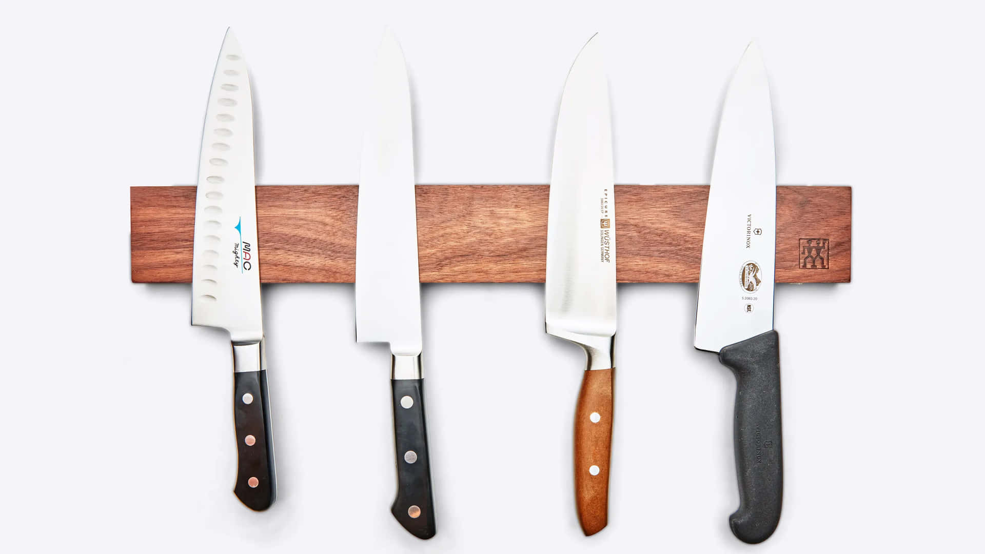 Four Knives Are Hanging On A Wooden Rack
