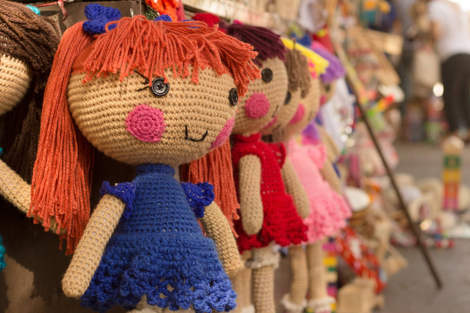 Knitted Cute Dolls On Display Wallpaper
