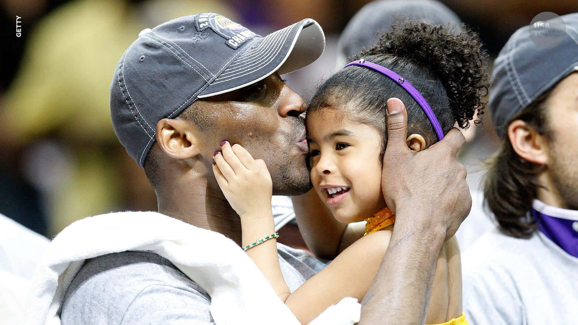 Caption: A heartfelt moment between Kobe and Gigi on the basketball court Wallpaper